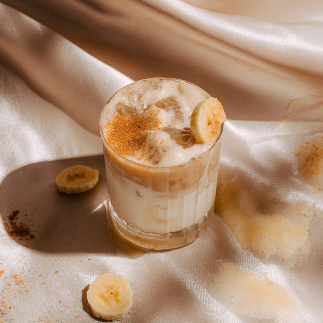 Iced Banana Bread Collagen Latte with ice cubes and straw