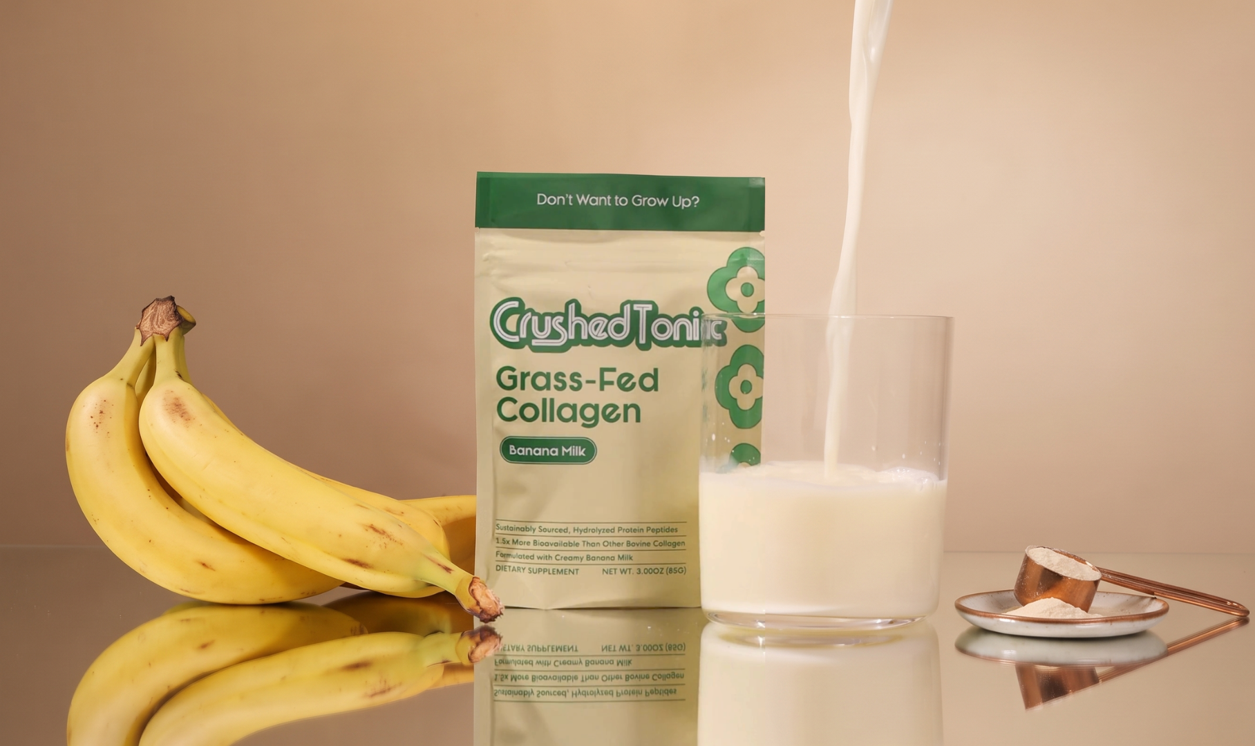 Crushed Tonic Banana Milk collagen pouch beside a glass of banana milk
